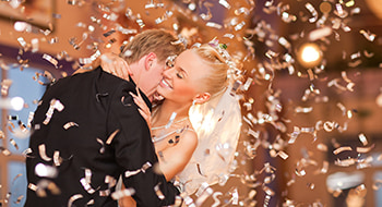 a bride and groom embrace on their wedding day
