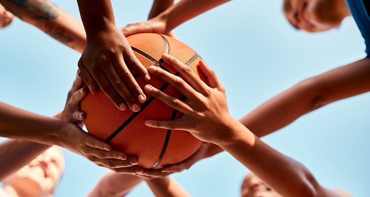 A basketball team huddles